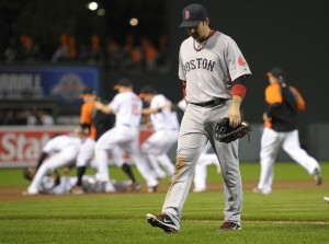 Boston Red Sox first baseman Adrian Gonzalez walks off the field as the Baltimore Orioles celebrate the Sept. 28 victory that helped cause the Sox to miss the playoffs.